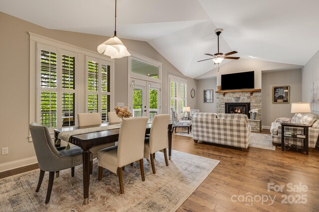 75 Balsam High Rd, Biltmore Lake, NC 28715 - dining room featuring wood finished floors, a fireplace, lofted ceiling, ceiling fan, and baseboards