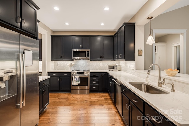 75 Balsam High Rd, Biltmore Lake, NC 28715 - kitchen featuring stainless steel appliances, a sink, light wood-style flooring, recessed lighting, and tasteful backsplash