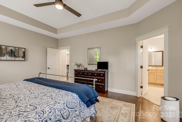 75 Balsam High Rd, Biltmore Lake, NC 28715 - bedroom featuring wood finished floors, ensuite bathroom, baseboards, a ceiling fan, and a tray ceiling