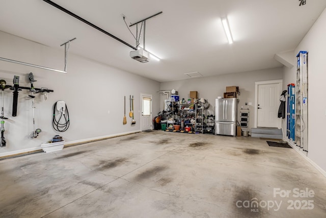 75 Balsam High Rd, Biltmore Lake, NC 28715 - garage with freestanding refrigerator, a garage door opener, and baseboards