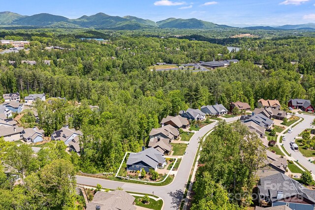 75 Balsam High Rd, Biltmore Lake, NC 28715 - aerial perspective of suburban area featuring a heavily wooded area and a mountainous background