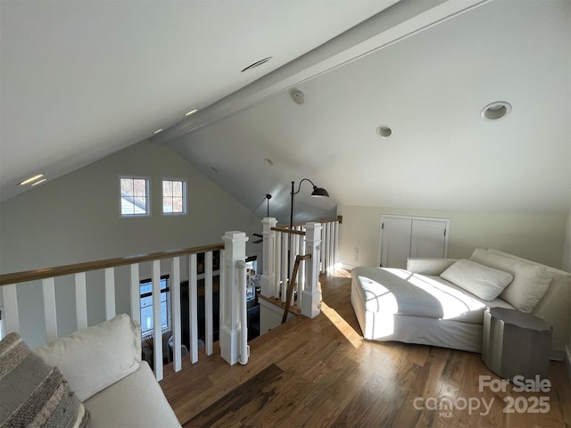 interior space with vaulted ceiling with beams and wood finished floors