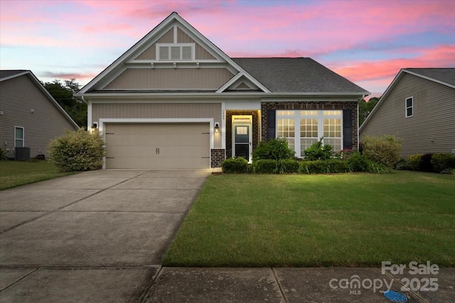 1409 Tupelo Rd, Clover, SC 29710 - view of front of home featuring a front yard, driveway, brick siding, and a garage