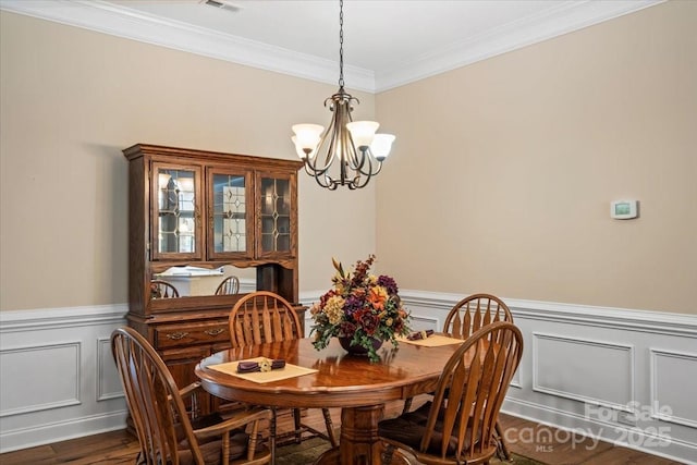 1409 Tupelo Rd, Clover, SC 29710 - dining room with a chandelier, ornamental molding, wood finished floors, a wainscoted wall, and a decorative wall