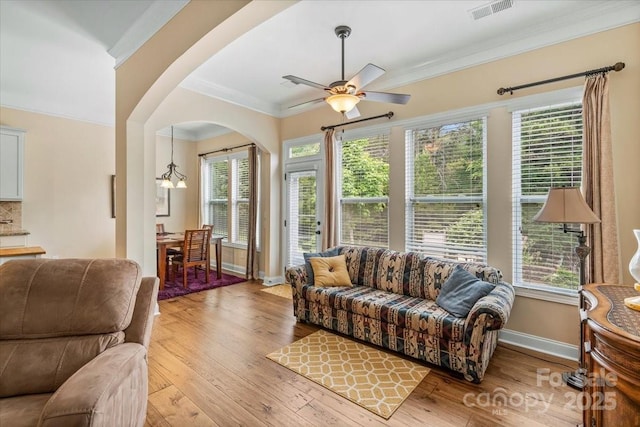 1409 Tupelo Rd, Clover, SC 29710 - living room with ceiling fan, arched walkways, wood-type flooring, crown molding, and baseboards