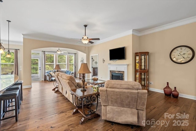 1409 Tupelo Rd, Clover, SC 29710 - living area featuring a glass covered fireplace, crown molding, a ceiling fan, baseboards, and hardwood / wood-style floors