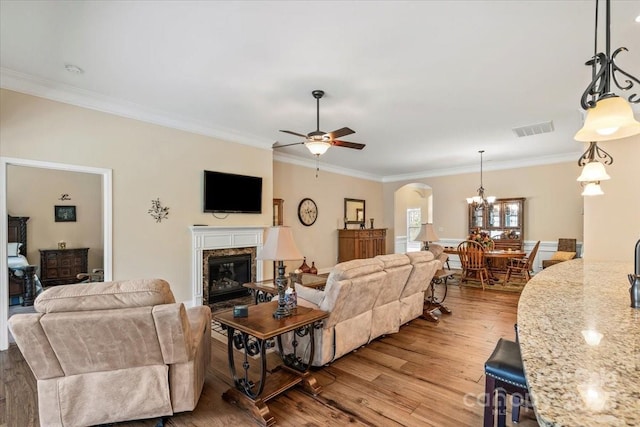 1409 Tupelo Rd, Clover, SC 29710 - living room with wood finished floors, ornamental molding, arched walkways, a ceiling fan, and a fireplace
