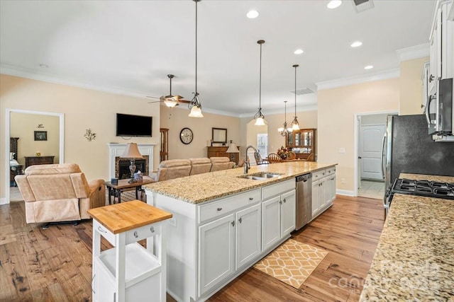 1409 Tupelo Rd, Clover, SC 29710 - kitchen featuring a sink, a center island with sink, appliances with stainless steel finishes, ceiling fan, and white cabinetry