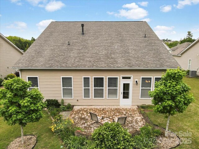 1409 Tupelo Rd, Clover, SC 29710 - back of property with a patio, central AC unit, a lawn, and a shingled roof