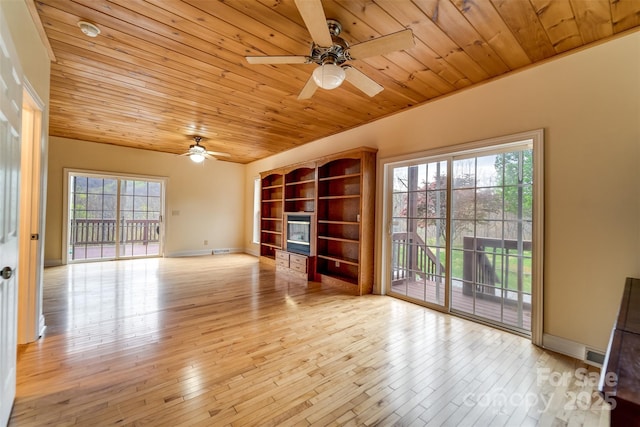 423 Baines Mountain Rd, Bryson City, NC 28713 - unfurnished room featuring hardwood / wood-style floors, built in shelves, a ceiling fan, wood ceiling, and baseboards