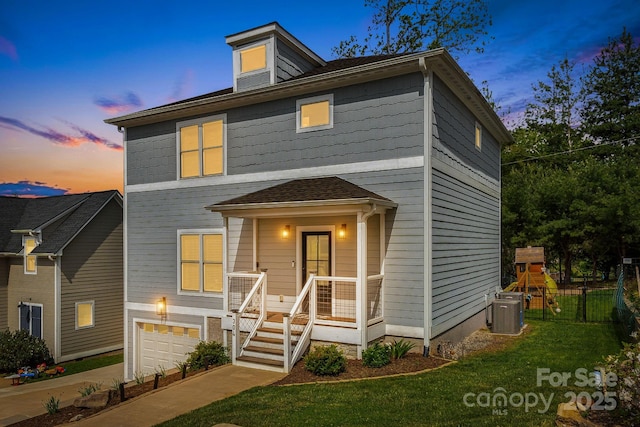 304 Magnolia Ridge Rd, Swannanoa, NC 28778 - view of front of house with central air condition unit, an attached garage, and a front lawn