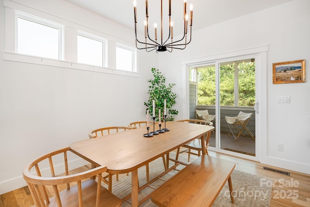 304 Magnolia Ridge Rd, Swannanoa, NC 28778 - dining area with a chandelier, baseboards, and light wood-style floors