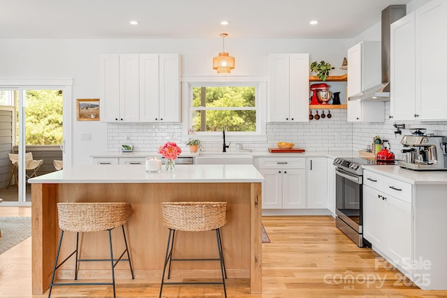 304 Magnolia Ridge Rd, Swannanoa, NC 28778 - kitchen featuring stainless steel electric range, a sink, open shelves, wall chimney exhaust hood, and a breakfast bar