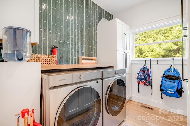 304 Magnolia Ridge Rd, Swannanoa, NC 28778 - laundry area with cabinet space, washer and dryer, and light wood-style flooring