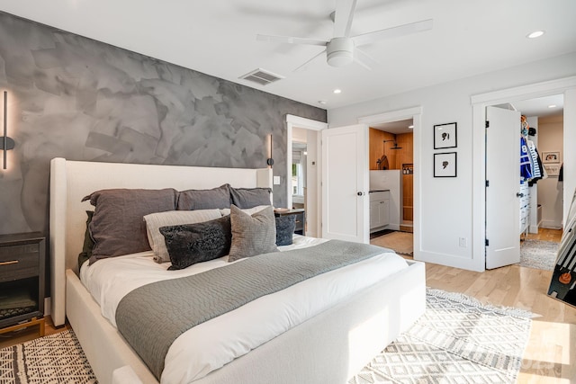 304 Magnolia Ridge Rd, Swannanoa, NC 28778 - bedroom featuring an accent wall, light wood-style floors, connected bathroom, recessed lighting, and a walk in closet