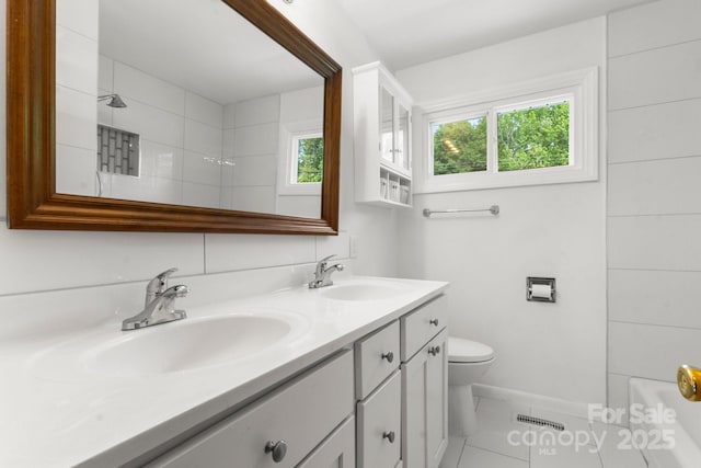 full bath featuring toilet and double vanity