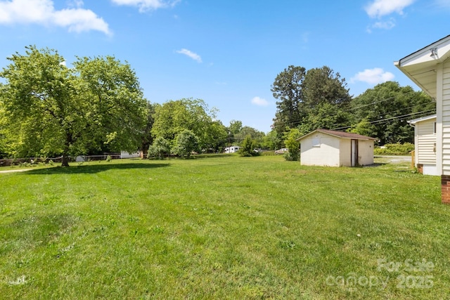 view of grassy yard with a storage unit and an outdoor structure