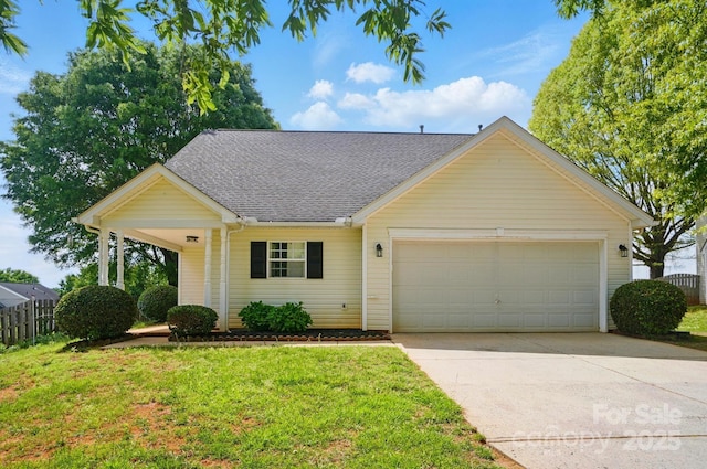 view of front of house featuring a garage, driveway, and a shingled roof