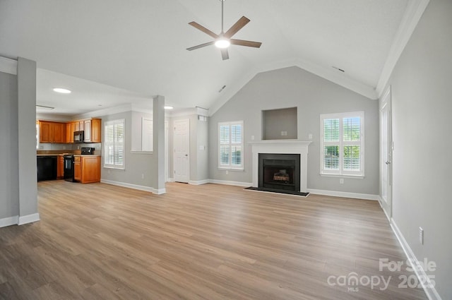 unfurnished living room with healthy amount of natural light, ceiling fan, light wood-type flooring, vaulted ceiling, and ornamental molding