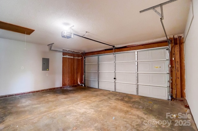 garage featuring electric panel, a garage door opener, and baseboards