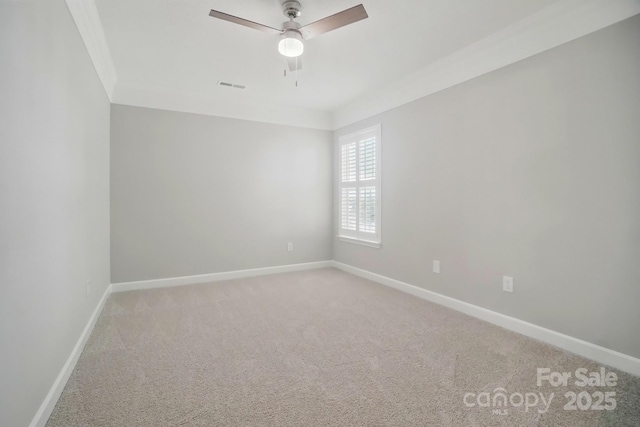 spare room with carpet, baseboards, and a ceiling fan