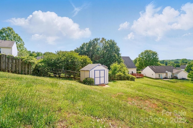 view of yard featuring a storage shed and an outbuilding