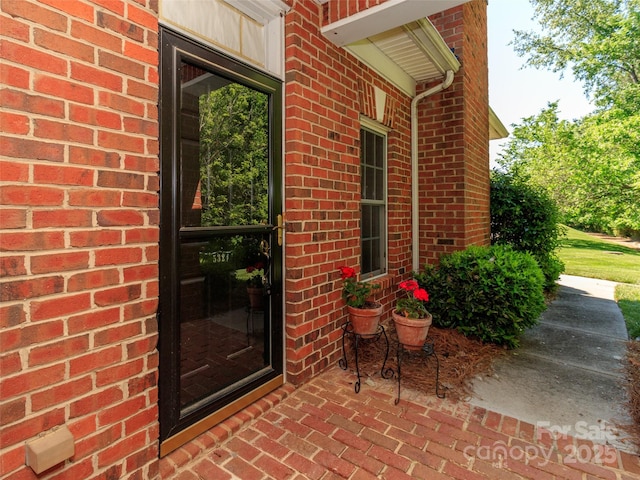 property entrance with brick siding