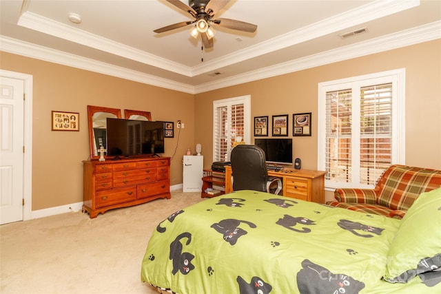 bedroom featuring crown molding, visible vents, baseboards, a raised ceiling, and light carpet