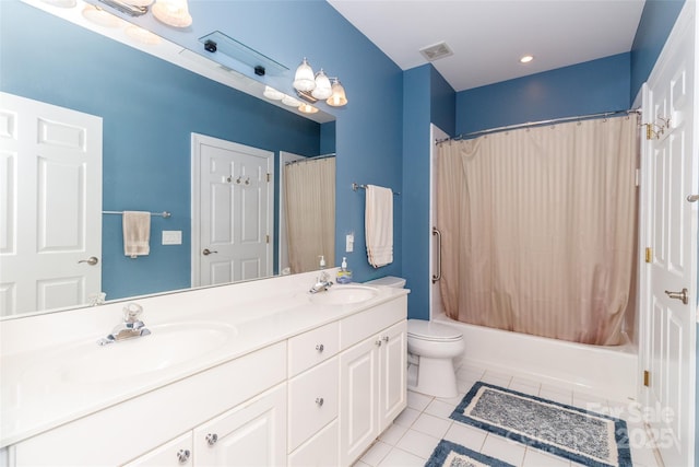 bathroom with double vanity, tile patterned floors, visible vents, and a sink