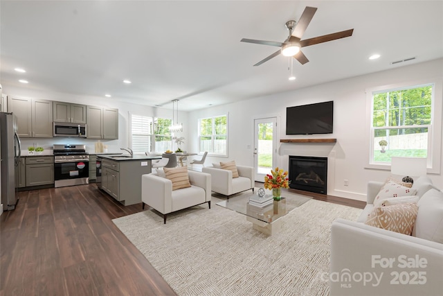 15 Myrtle Lee Cv, Arden, NC 28704 - living room with dark wood-style floors, recessed lighting, a ceiling fan, a glass covered fireplace, and baseboards