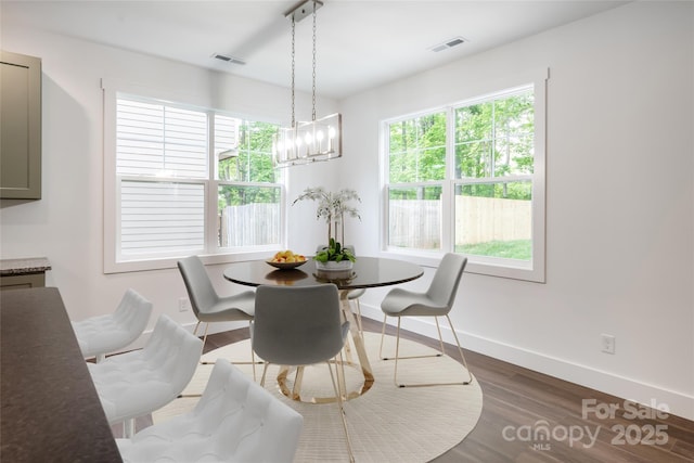 15 Myrtle Lee Cv, Arden, NC 28704 - dining area featuring baseboards, wood finished floors, healthy amount of natural light, and a chandelier