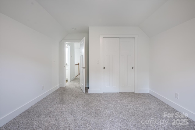 15 Myrtle Lee Cv, Arden, NC 28704 - unfurnished bedroom with lofted ceiling, carpet flooring, baseboards, and a closet