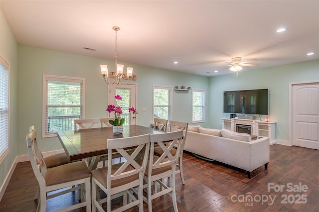 210 Holmes Dr, Spartanburg, SC 29303 - dining space featuring dark wood-style flooring, a chandelier, recessed lighting, a ceiling fan, and a fireplace