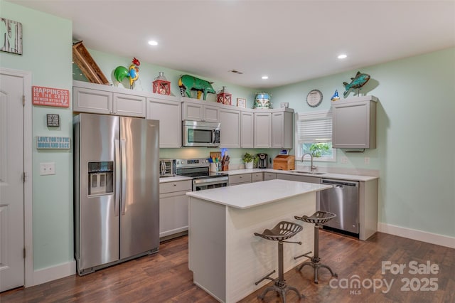 210 Holmes Dr, Spartanburg, SC 29303 - kitchen featuring appliances with stainless steel finishes, light countertops, a center island, recessed lighting, and dark wood-style flooring