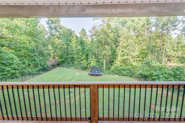 210 Holmes Dr, Spartanburg, SC 29303 - view of grassy yard featuring a trampoline, a wooden deck, and a view of trees