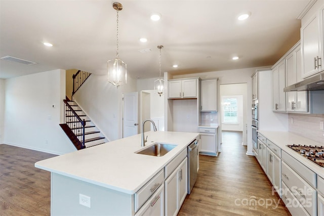 kitchen with a sink, light wood-style flooring, visible vents, and appliances with stainless steel finishes