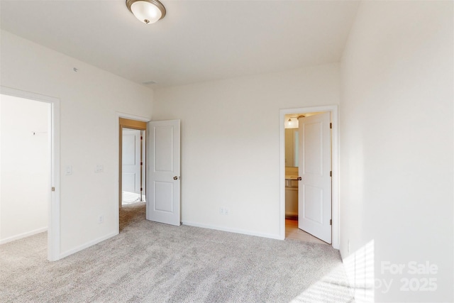 unfurnished bedroom with carpet floors and baseboards