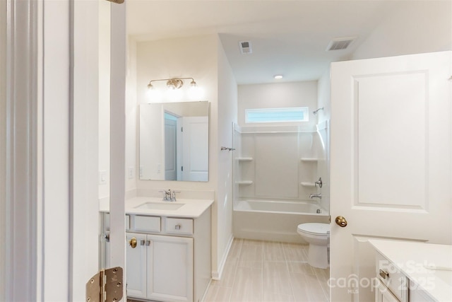 bathroom featuring toilet, visible vents, vanity, and washtub / shower combination