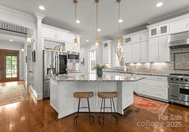 400 Hunter Ln, Charlotte, NC 28211 - kitchen featuring appliances with stainless steel finishes, wall chimney range hood, crown molding, white cabinets, and recessed lighting