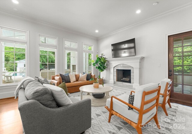 400 Hunter Ln, Charlotte, NC 28211 - living area featuring plenty of natural light, recessed lighting, ornamental molding, a fireplace with raised hearth, and light wood finished floors