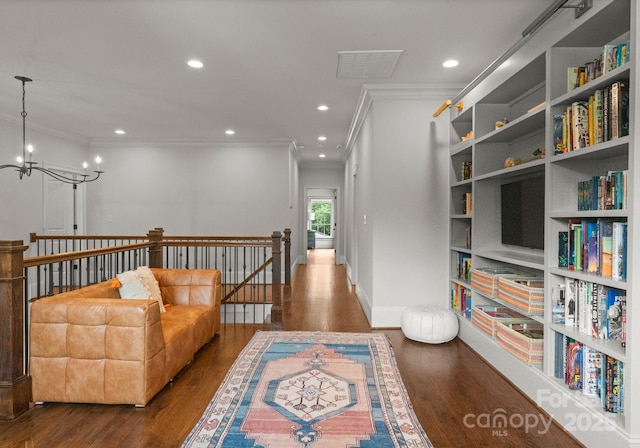 400 Hunter Ln, Charlotte, NC 28211 - living area with crown molding, an upstairs landing, wood finished floors, a chandelier, and recessed lighting