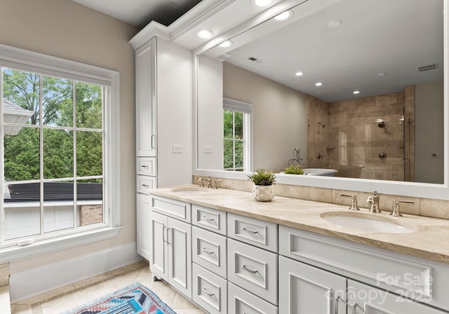 400 Hunter Ln, Charlotte, NC 28211 - full bath with a tile shower, recessed lighting, double vanity, tile patterned flooring, and baseboards