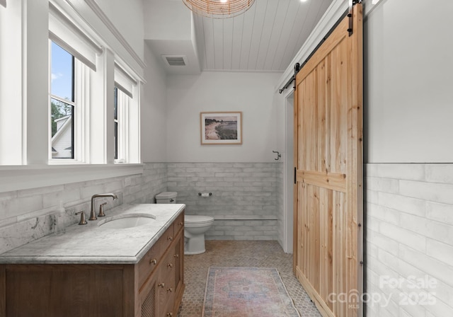 400 Hunter Ln, Charlotte, NC 28211 - bathroom with vanity, a wainscoted wall, toilet, and tile walls