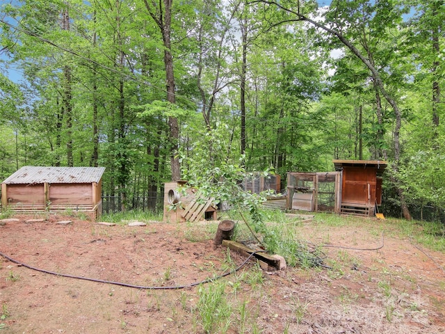 view of yard with an outdoor structure, exterior structure, and fence