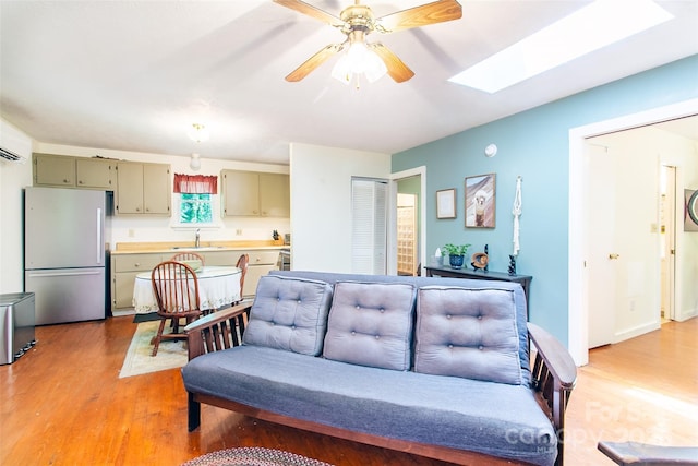 70 Lake Sega Cir, Brevard, NC 28712 - living room featuring light wood-type flooring, ceiling fan, and a skylight