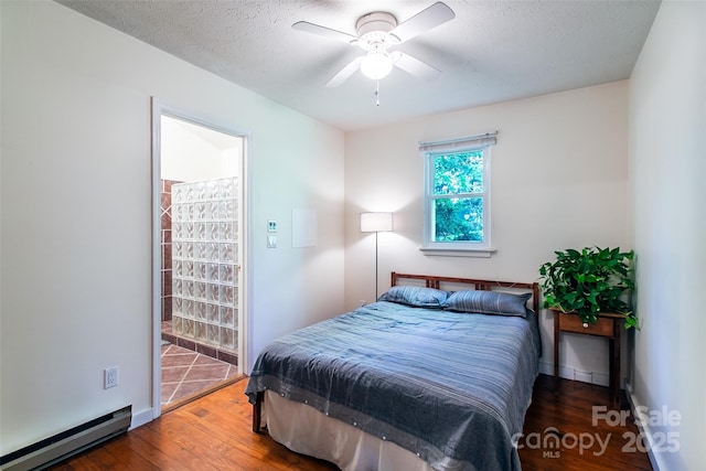 70 Lake Sega Cir, Brevard, NC 28712 - bedroom with a baseboard heating unit, wood finished floors, a textured ceiling, baseboards, and a ceiling fan