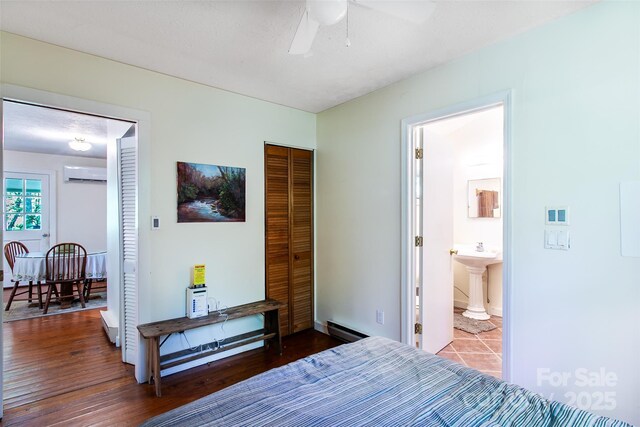 70 Lake Sega Cir, Brevard, NC 28712 - bedroom featuring a sink, baseboard heating, a closet, a wall mounted air conditioner, and ensuite bathroom