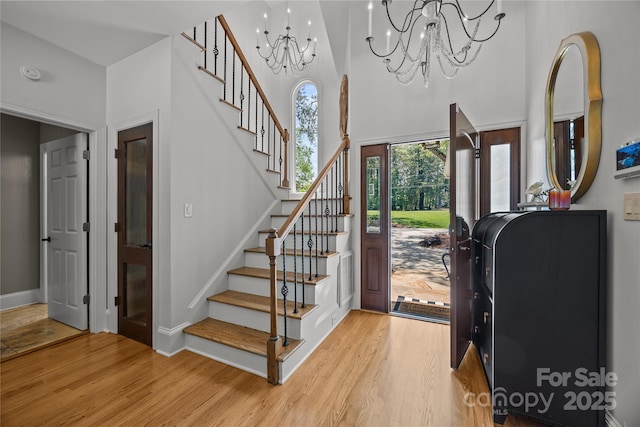 19614 Meta Rd, Cornelius, NC 28031 - entrance foyer featuring a chandelier, light wood-style flooring, stairway, a towering ceiling, and baseboards
