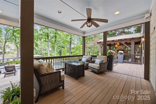 19614 Meta Rd, Cornelius, NC 28031 - deck with outdoor lounge area, a ceiling fan, and view of scattered trees