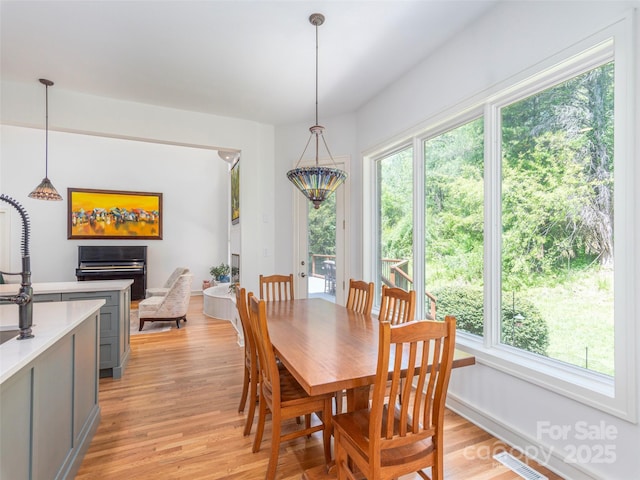 dining room featuring visible vents and light wood-style flooring